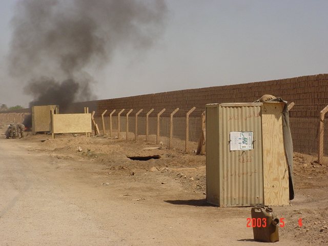 Smoke rising beyond the compound wall, May 2003.